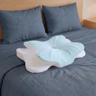 The pillow on a made bed, seen from the foot of the bed.